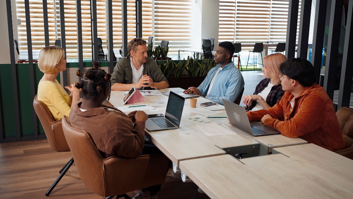  A diverse team discussing strategies in an office, representing multilingual collaboration in global business