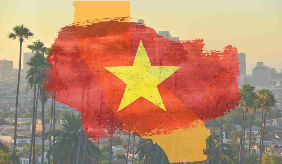 Vietnamese flag over a California map with palm trees and city buildings.
