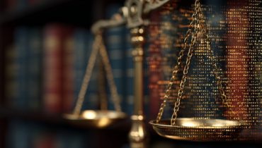 Golden scales of justice in front of law books, overlaid with lines of computer code